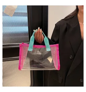 Detail of transparent PVC tote bag with pink mesh panels and TOTE BAG print