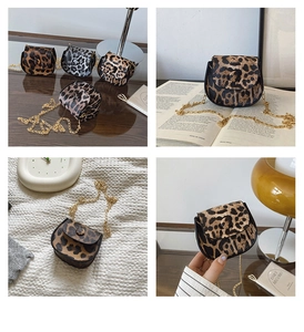 Detailed view of mini leopard print saddle bag with gold chain and flap closure