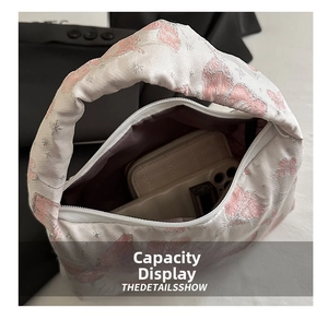 Internal view of butterfly embroidered handbag showing storage capacity for a phone
