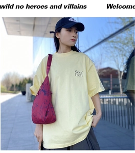 Detail of dark red tie-dye texture nylon chest bag paired with a pale yellow T-shirt