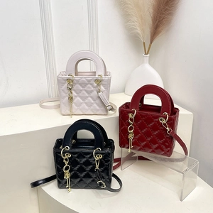 Quilted crossbody bags in cream, burgundy, and black with metallic key charms