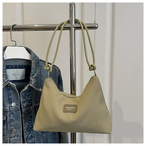 Detail of light green pleated shoulder bag with knotted strap and brand label detail