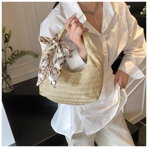 Détail du sac à main en paille avec foulard en soie et motif de tissage en chevrons