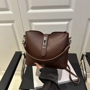 Retro coffee brown bucket bag with silver metal clasp and slim shoulder strap