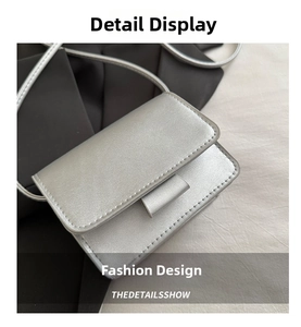 Detailed top view of silver rectangular crossbody bag with metallic faux leather texture