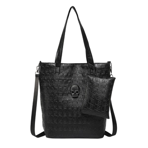 Large black leather tote bag with skull embossing and metallic skull studs shown in front view
