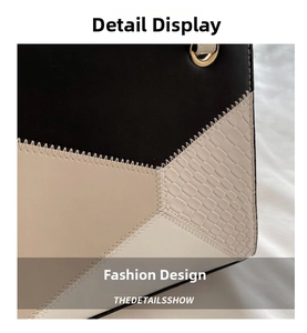 Close-up of contrast stitching and mixed crocodile texture on a large shoulder bag