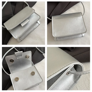 Silver mini square crossbody bag details showing magnetic snaps and glossy PU texture