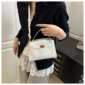 White mini trapezoid handbag in litchi leather with gold turn-lock and shoulder strap
