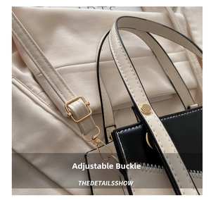 Close-up of adjustable strap with gold buckle and leather texture of contrast bag
