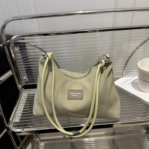 Pleated striped avocado green tote bag with luxury leather label and zipper closure