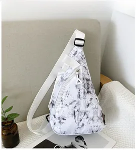Detail of white nylon crossbody bag with marble print and triangular zipper pull