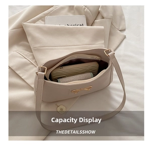 Internal view of beige shoulder bag showing spacious storage for a smartphone
