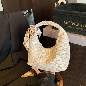 Chic cream straw hobo handbag with a patterned silk scarf handle and crescent shape