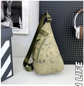 Detail of triangular nylon chest bag with olive green marbled texture and zip pocket