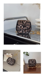 Detailed views of leopard print saddle bag with golden chain and faux leather texture