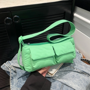 Neon green nylon crossbody bag with dual utility pockets and padded design in casual style