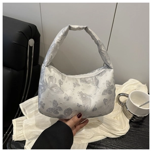 Detail of silver silk hobo bag featuring intricate butterfly brocade and top zipper