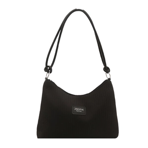 Black pleated bucket bag with textured fabric and adjustable knot shoulder strap