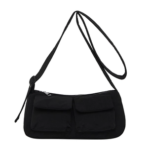 Minimalist black nylon canvas crossbody bag with dual utility pockets and adjustable strap