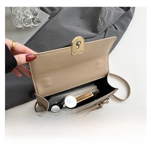 Internal view of beige crossbody bag showing space for phone and makeup accessories