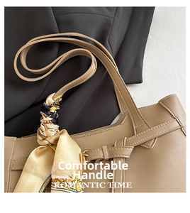 Detail of khaki leather tote handle wrapped with a vintage print silk scarf decoration
