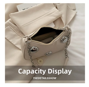 Top view of beige PU crescent bag showing interior capacity and silver metal studs