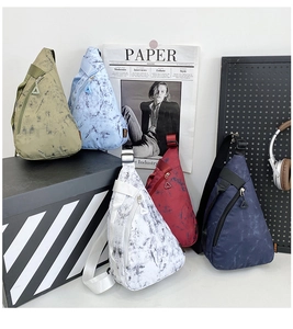 Nylon sling bags in olive, blue, and marble pattern with triangle zipper details