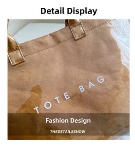 Macro detail of brown tote bag with wrinkled texture and white TOTE BAG lettering print