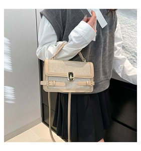 Detail of glitter fabric texture and gold twist lock on this trendy shoulder handbag