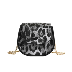 Mini leopard print crossbody saddle bag with gold chain strap in silver and black leather
