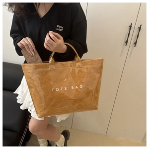 Brown paper texture tote bag featuring a minimalist white TOTE BAG print in interior setting
