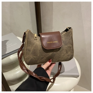 Gros plan d'un sac vintage marron avec bandoulière nouée et lettrage doré