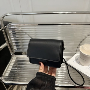 Minimalist black leather mini crossbody bag for girls with rectangular flap design