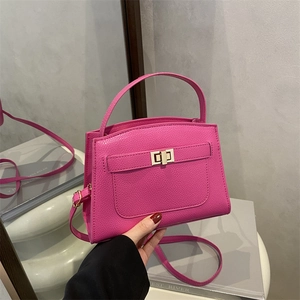 Litchi texture pink leather handbag with gold twist lock and adjustable shoulder strap