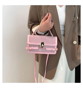 Pink crossbody square bag featuring sparkly glitter flap and golden metallic clasp detail