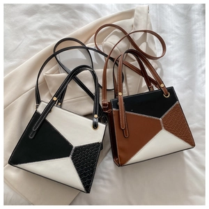 Detail view of geometric patchwork texture on large capacity crossbody handbags