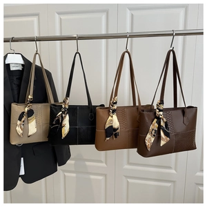 Detail of four color tote bags with patchwork texture and decorative silk scarves