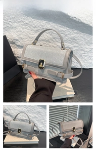 Detail of silver crossbody bag with sequin lid, golden twist lock and leather handle