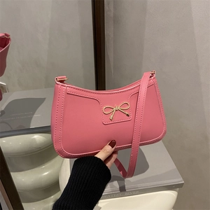 French style soft pink shoulder bag with a gold bow accent and sleek faux leather finish