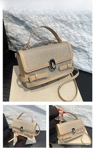 Detail view of khaki handbag with sparkling rhinestones and elegant gold hardware lock