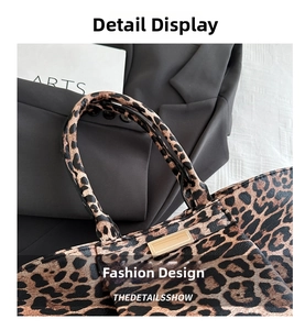 Detail shot of leopard print tote bag with pebbled leather texture and gold metal accents