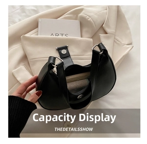 Detailed interior view showing the capacity of this black half-moon matte leather bag