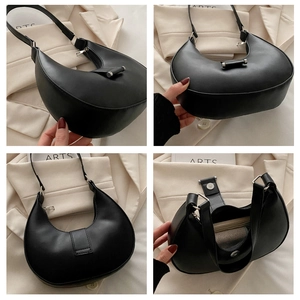 Detail view of black crescent shoulder bag with silver hardware and interior layout
