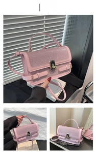Detail of pink sequin handbag featuring golden twist lock and shimmering diamond texture