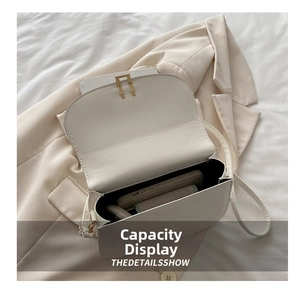 Interior view showing the storage capacity for a smartphone in the white flap crossbody bag