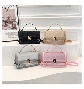 Detail of four sequin small square bags in black, gold, silver and pink with twist locks