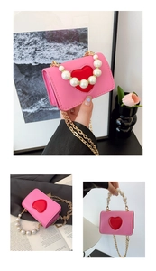 Vue détaillée du mini sac rose avec applique cœur rouge et grande poignée en perles
