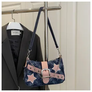 Close-up of Y2K denim bag featuring pink star patches and decorative silver chains
