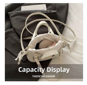 Internal view of white pebble leather handbag with drawstring closure showing storage capacity